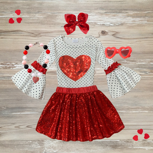 girls in a stylish Valentine's Day outfit with red glitter skirt and heart design top, sequin red valentine's day girls outfit trendy, kids boutique clothing, stylish red sequin skirt and white long-sleeve polka dot top with heart design,