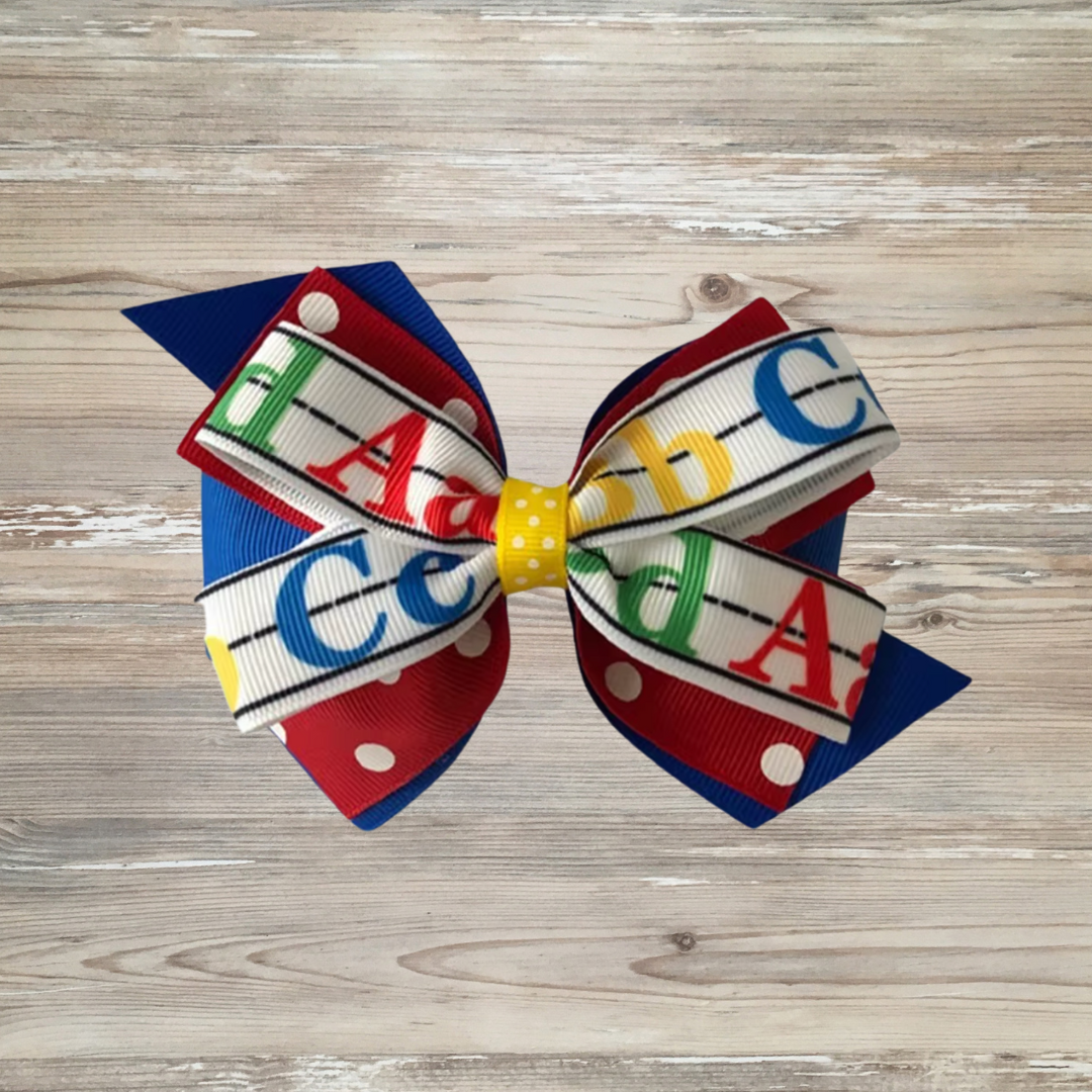 back to school hair bow, ABC hair bow for girls, girls school hair accessory, alphabet bow for toddler, preschool bow, teacher theme bow, kindergarten hair bow, Colorful girls hair bow with layered ribbon featuring A, B, C alphabet letters on handwriting lines, red polka dot ribbon, and yellow center – perfect back-to-school accessory for toddlers and kids