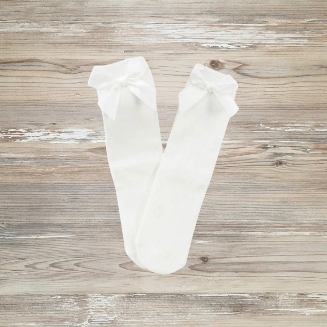 Elegant white knee-high socks for girls with satin bows, soft cotton fabric, secure fit, perfect for toddlers and kids’ party, school, or daily outfits
White knee-high girls socks with large satin bows, breathable cotton blend, stretchy fit, ideal for toddlers and kids, dressy or casual wear