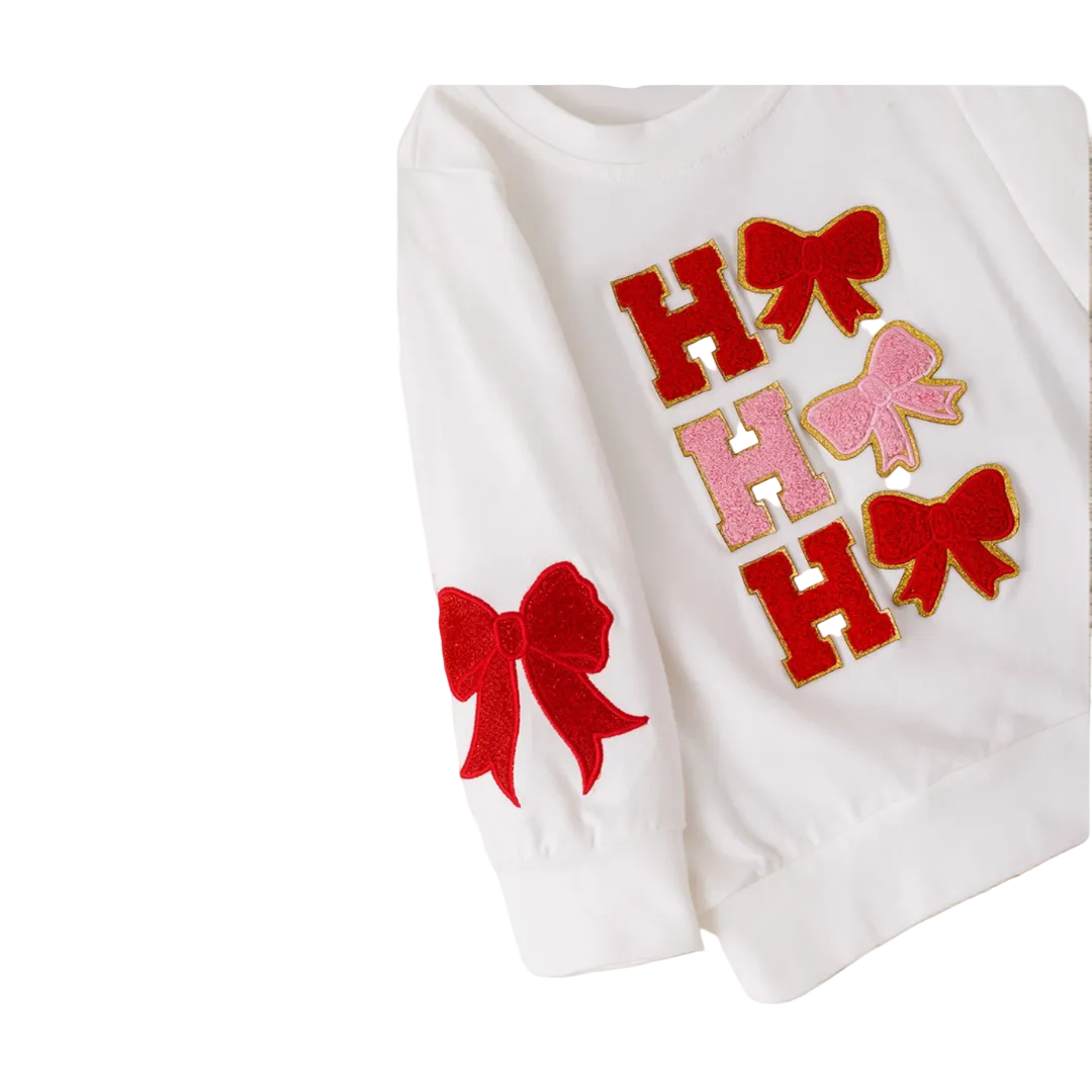 Coquette-style girls' white Christmas top with "Ho Ho Ho" lettering and bows, paired with red sequin bell bottom pants, girls chirstmas red sequin outfit, girls boutique clothing, sequin pants christmas outfit
