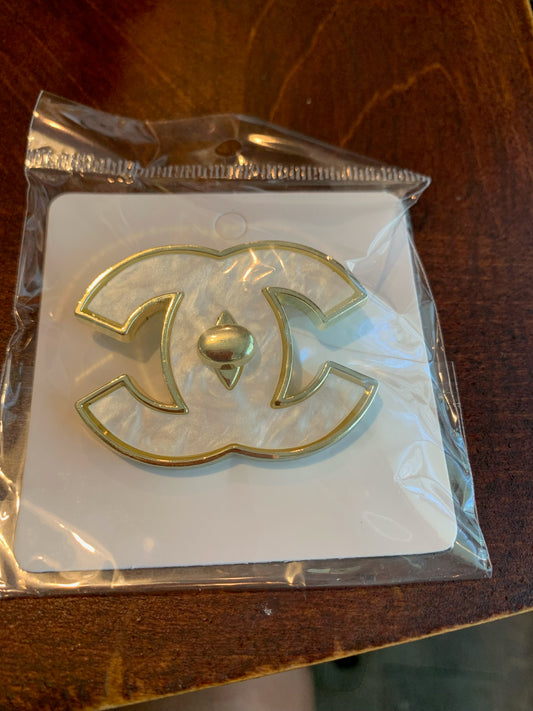 A gold-tone pearl interlocking CC logo charm,  Chanel inspired brooch,  chanel brooches, chanel pearl interlocking brooch