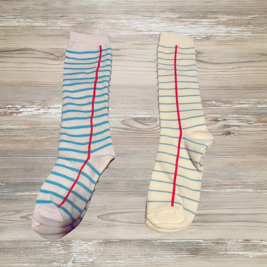 Girls knee-high socks with notebook paper design featuring blue lines and red margin, perfect for school outfits or back-to-school style. notebook knee high socks, notebook paper knee high socks