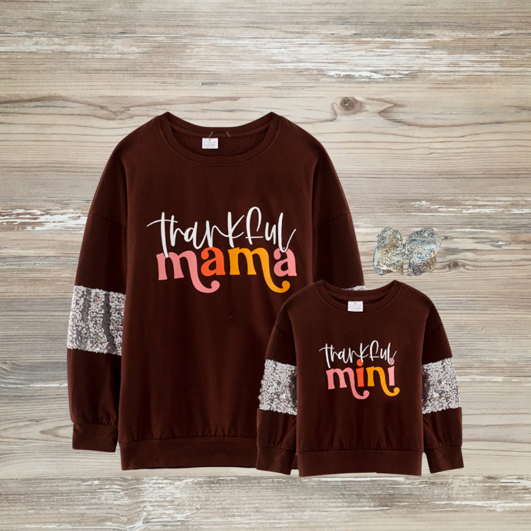 Matching “Thankful Mama” and “Thankful Mini” fall sweatshirts in rich brown with sequin sleeve accents, perfect for Thanksgiving family outfits. matching mommy and me matching mama and mini online kids boutique