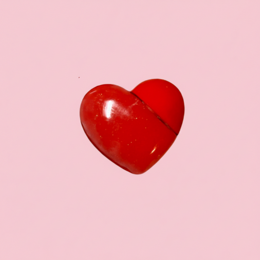 Heart-shaped kids' lip gloss in a bright red heart tube. A vegan, strawmelon-flavored clear gloss with a high-shine finish, designed for children's beauty, heart-shaped lip gloss container for kids, compact design is smooth and glossy, clear-applying vegan formula inside. Perfect for children's Valentine's Day gifts and play makeup collections, pocket-sized, ideal for little hands. A non-toxic, vegan, and carmine-free clear gloss for a yummy, sweet treat for the lips, lip gloss for kids